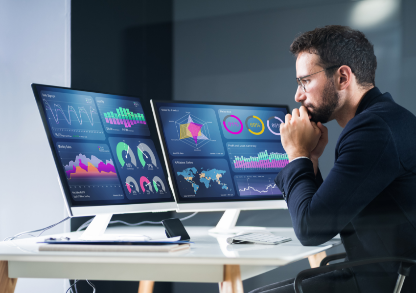 Image of man in front of computer screens